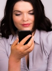 Woman smiling reading on her phone
